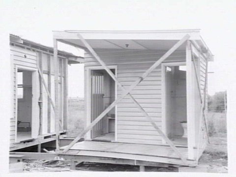 Housing Commission of Victoria pre-fabricated timber houses, showing construction in kitchen, bathroom and laundry, transfer of sections to building sites and positioning of houses on blocks at Sandringham Estate, 1949