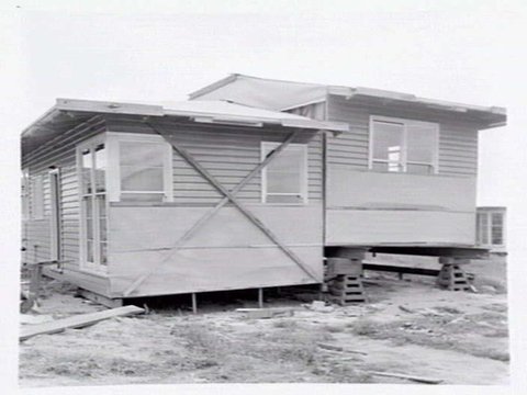 Housing Commission of Victoria pre-fabricated timber houses, showing construction in kitchen, bathroom and laundry, transfer of sections to building sites and positioning of houses on blocks at Sandringham Estate, 1949
