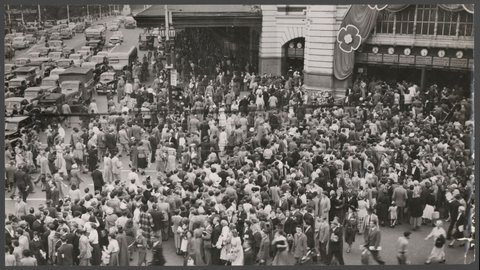 Large crowd of people at Flinders Street Railway Station, Melbourne, during tram strike, 1954