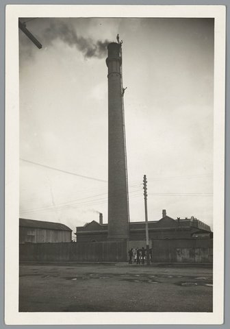 Steeplejacks repairing lightning conductors on chimney stack at Spencer Street Melbourne Railways, 1917