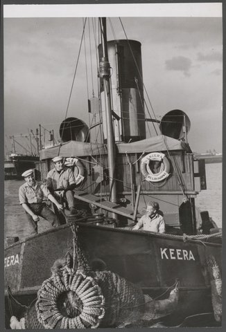 Three men standing on the tugboat Keera, Melbourne, 1945