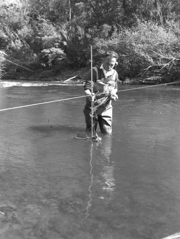 HYDROGRAPHER WADING YARRA RIVER TO MEASURE FLOW, 1954