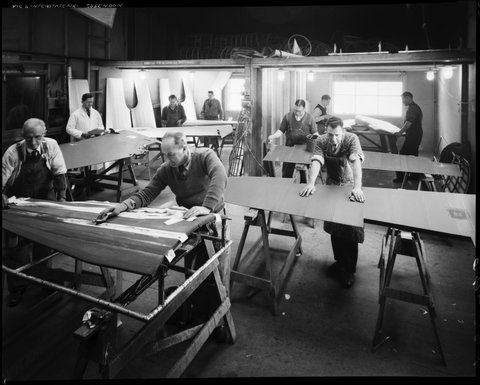 At Essendon factory with men producing aircraft wings for war effort, c. 1943