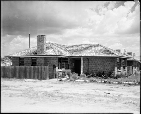 View from a vacant block next door, of a Housing Commission house with a timber entrance portico, Coburg, Preston and Heidelberg area, c. 1947