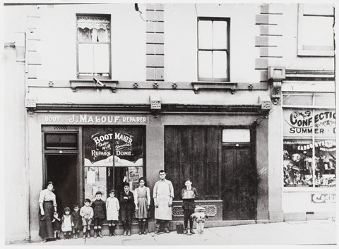 Joseph and Susan Malouf and family outside their shop and dwelling at 58 Lonsdale St., Melbourne, 1918