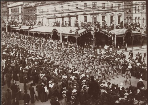 Victorian army contingent, Second Boer War, marching past Royal Mail Hotel, corner Swanston and Bourke streets, Melbourne, c. 1900