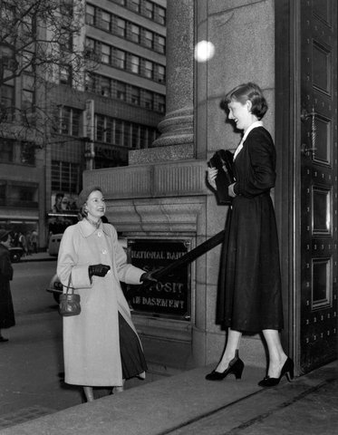 Female bank clerk and another woman on entrance steps National Bank of Australasia State Head office 279 Collins Street Melbourne, 1953