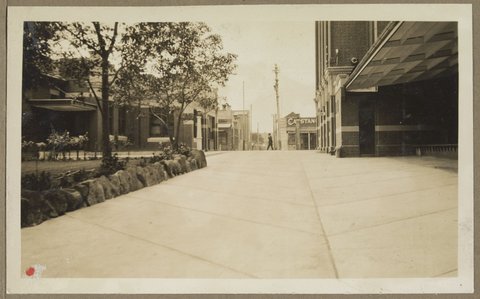 Looking out gates at Bryant & May, Richmond, to street, 1928