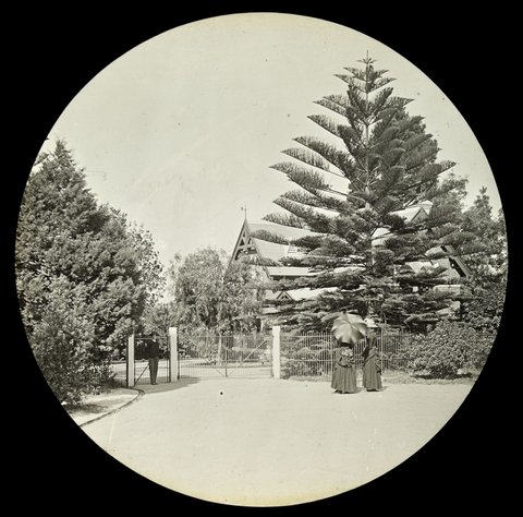 Man and two women standing at the entrance to the Botanical Gardens, Melbourne, Victoria, 1890–1901
