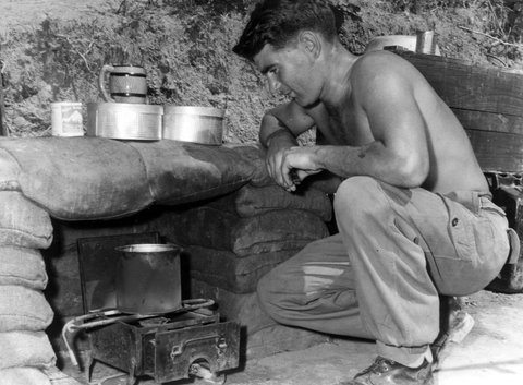Pte A. "Cactus" Stephens (Brighton, Vic.), boiling the billy in his tent in Korea, 1953