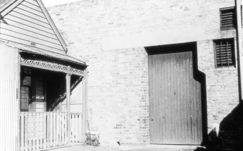 Melbourne. Weatherboard house and brick building, c. 1935