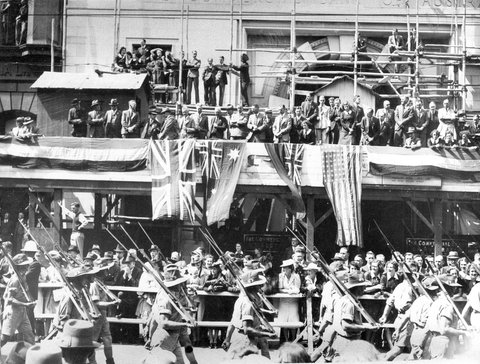 Soldiers marching through Melbourne streets, watched by large crowd, c. 1941