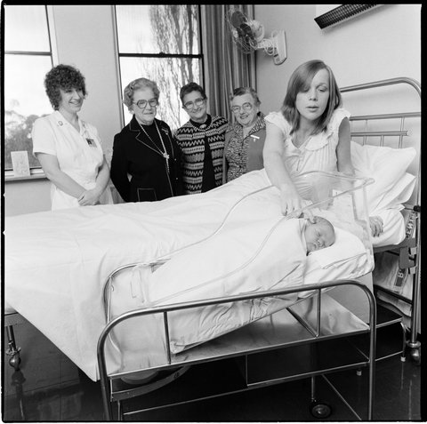 St. Georges hospital, Kew. Ladies Auxiliary and a bassinet - with new mother and baby, 1979