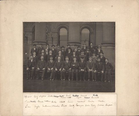 Staff of Melbourne Public Library seated in front of library, Swanston Street, Melbourne, Victoria, 1896–98