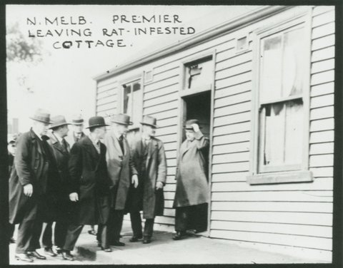 [North Melbourne] Premier leaving rat-infested cottage, c. 1935