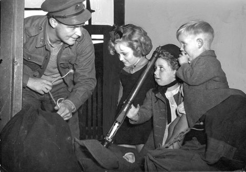 A.I.F. Signaller V. P. Williamson, recently arrived at Spencer Street Station reunited with his family, c. 1942