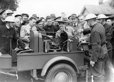 Mr. V. L. Solomons instructing members of the Brighton A.F.S. [i.e. Auxiliary Fire Service] on the workings of the mobile trailer pump, c. 1942