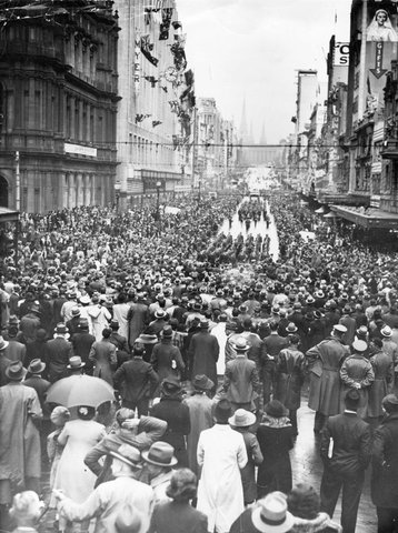 Large crowds fill intersection of Bourke and Elizabeth Streets watching A.I.F. march, 1939–44