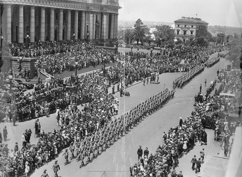 Troops marching [in Spring St., Melbourne, passing Parliament House], c. 1940