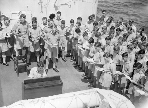 Captain H. J. Buchanan from Melbourne, Commanding Officer of H.M.A.S. Napier conducting special thanksgiving church service on the deck of the Napier, day after peace was declared, 1945