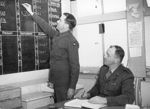 Amenities staff discussing programmes to be held in St. John Hall, Heidelberg Military Hospital, c. 1943