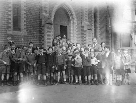 Carlton. [Group portrait of a man and children outside a church], c. 1935