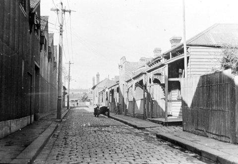 Melbourne. Terrace houses in narrow street, c. 1935