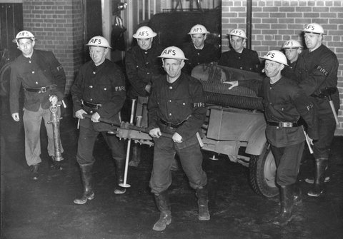 Members of the Nth. Fitzroy A.F.S. [i.e. Auxiliary Fire Service] moving of [i.e. off], c. 1942