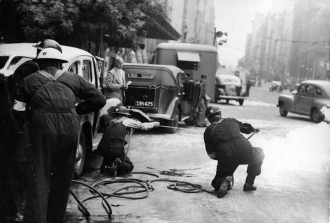 Men extinguishing an 'incendiary bomb' in Collins Street during A.R.P. testing, 1939–45