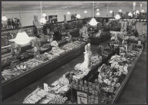 Interior of Coles store St. Kilda showing counters of merchandise including toilet paper, 1954