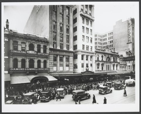 Elevated view across road towards crowds on path in front of Coles Variety Store in Deva House Melbourne Store No. 4, 1930–35