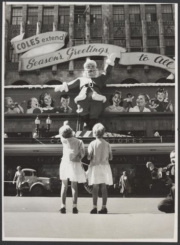 Two girls looking at Christmas decorations on the Coles Bourke Street Store No. 12, 1954