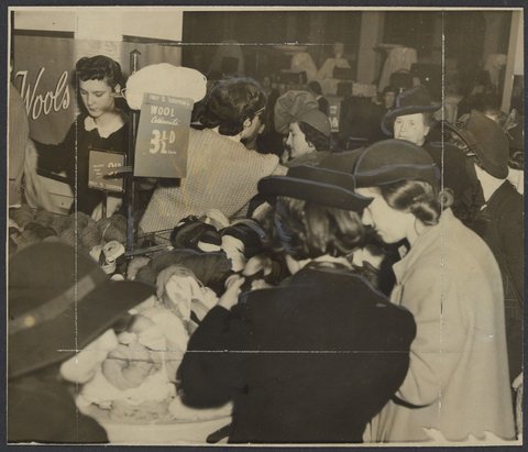First day of coupon system, women buying skeins of wool using ration books during World War II, Mantons Bourke Street, 1942