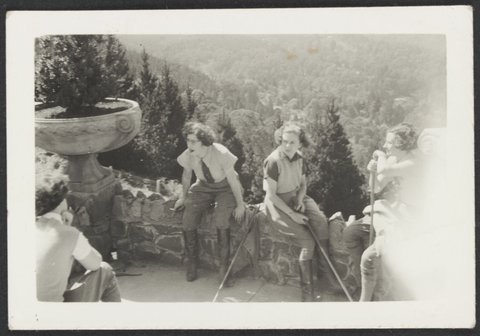 Cynthia Cox (Richmond) and two other women sitting wearing jodhpurs and holding polo mallets, 1940