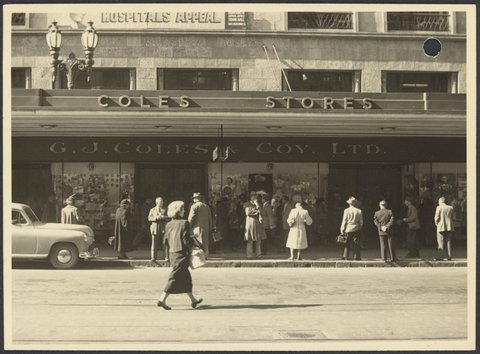 View across street of facade with Hospitals Appeal banner on Coles Bourke Street Store No. 12, 1940–50