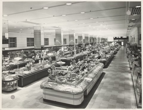 Interior ground floor showing tables of merchandise 'This week's feature' barley sugar on display in Bourke Street Store No. 12, 1940s