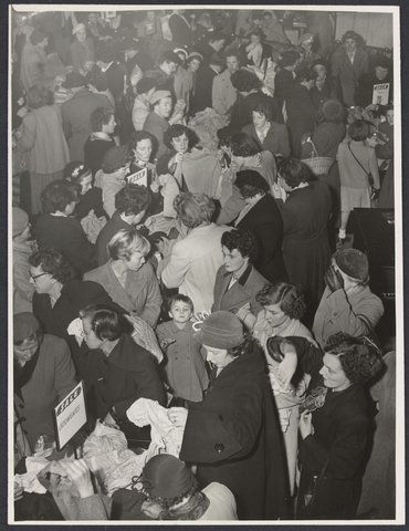 Large crowd of shoppers in store rummaging through sale items in Mantons Bourke Street, 1942–51