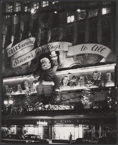 Exterior view of Coles store in Bourke Street Melbourne displaying a big Santa Claus 25' high with a waving left arm Store No. 12, 1954