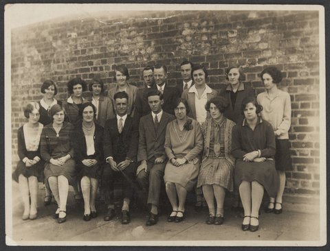 Warehouse staff four women and four men in two rows outside of Collins Street building, 1930–35