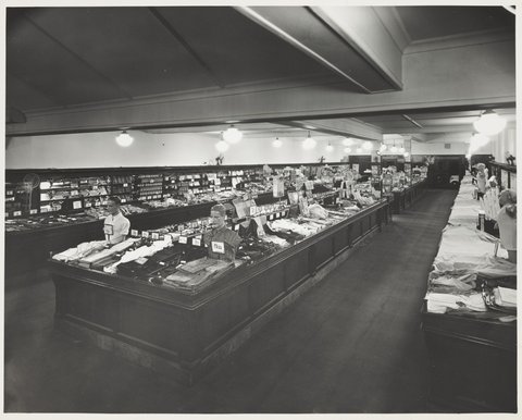 Interior of Coles store with displays for merchandise including check shirts for 8/11 Coburg Store No. 21, 1947