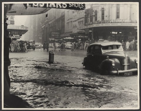 Flooding looking north over corner of Pitt and King Streets from front of Pitt Street Coles Variety Store No. 130, 1940–50