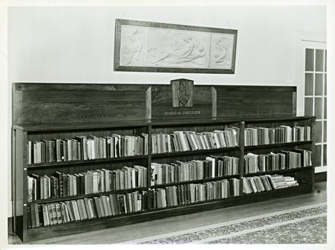 Book case with carved coat of arms and inscription: Verdon Library, probably at Melbourne University, Victoria, 1920–48