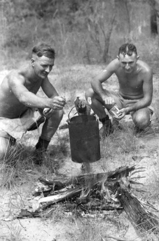 Axemen during "Meal-time" at a Mobile Works Squadron in Northern Australia. A.C.1 E. H. Russell of Melbourne (Vic.) and A.C.1 G. Theyers of Swan Hills [Hill] (Vic.) are seen boiling the billy, c. 1944