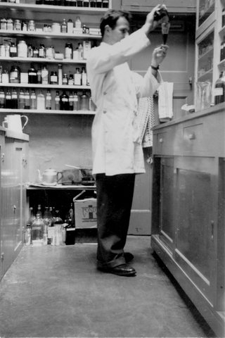 Pharmacist, Frank Montegano, in the dispensary of his shop, Monte's Pharmacy, at 256 Lygon Street, Carlton, c. 1951