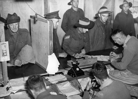 Dischargees signing papers at S.D.D. Royal Park, c. 1944