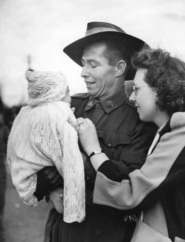 Pte. F. G. Jones, of Chelsea, at Royal Park, with wife and baby son after five years of service, 1942–48