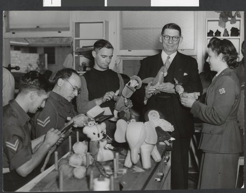 Lord Mayor Cr. Nettlefold, Sgt. L Annand and Cpl. W. S. Stonehouse inspecting toys from soldier patients at Heidelberg for the Lord Mayor's Toys for Britain appeal, c. 1944