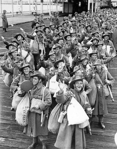 A.I.F. men of the 2nd contingent wave as they wait to embark from Port Melbourne, c. 1940