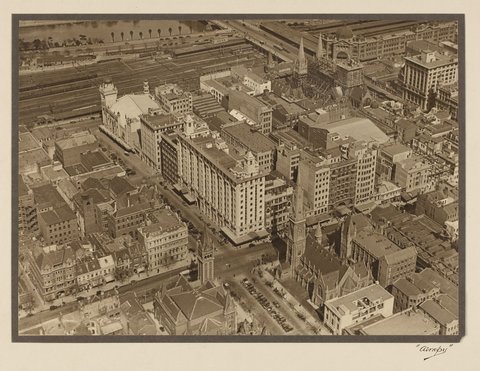 View of the intersection of Russell and Collins Streets looking south-west, showing the spires of St. Paul's under construction, 1927–28