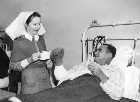 Nurse tending to casualty of Battle of Tarakan, Indonesia at Heidelberg military hospital, c. 1945